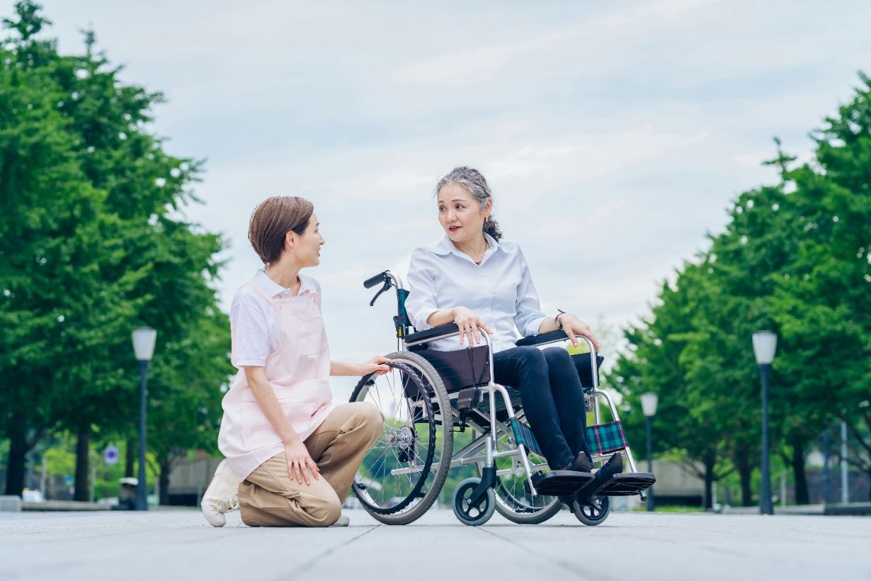 Caregiver taking out senior woman in her wheelchair