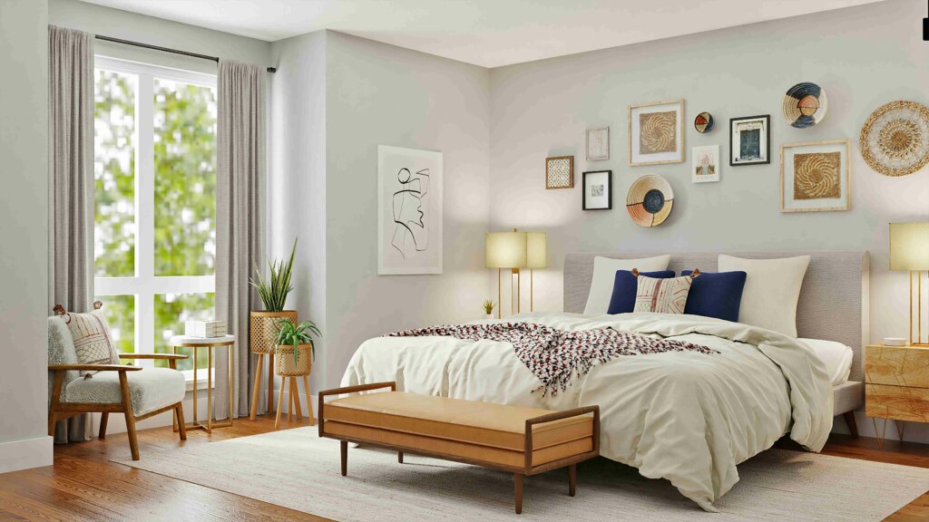 Bright and airy bedroom in NDIS housing with a neatly made bed, eclectic wall decor, and a sitting area near the window.