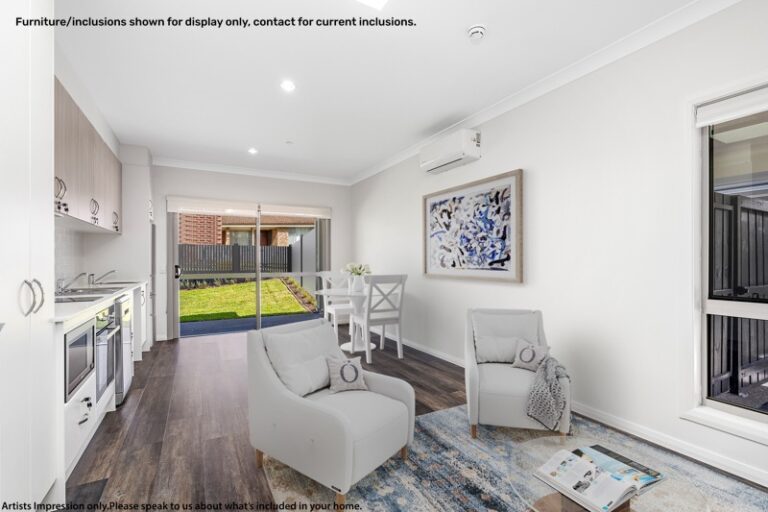 A modern living room in Narraweena, Sydney, features white furniture, a dining area, kitchen appliances, and a door leading to a serene backyard. Text on the top left and bottom of the image provides a disclaimer about display items.